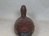 an image of a small wooden object on a white surface