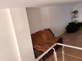 an image of a living room with wood floors and white walls