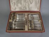 a lot of silver spoons in a wooden case