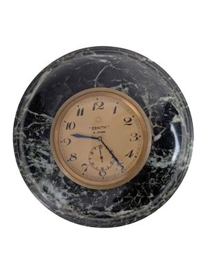 marble clock with black and gold face on a white background