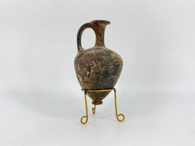 a vase that is on a stand on a white surface
