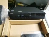 a box with a computer and a remote in it