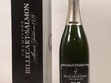 the bottle of champagne is next to a box of wine