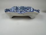 a blue and white bowl on a white table