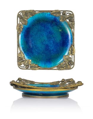 a blue plate and a gold plate on a stand