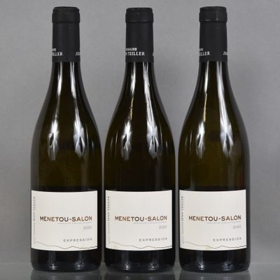 three bottles of wine sitting on top of a table next to each other