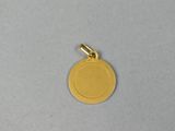 a close up of a gold coin on a white surface