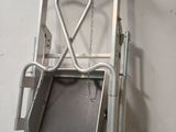 a ladder with a chair attached to it hanging on a wall