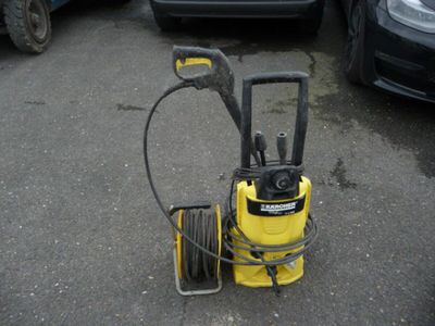 a yellow pressurer that is sitting in the parking lot