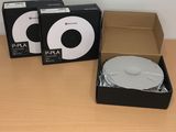 two boxes of mp3 players sitting on a table next to each other