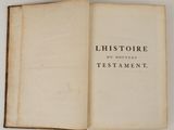 an open book on a white surface with the title of historire du nouveaus testament