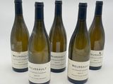 four bottles of wine are lined up on a white surface