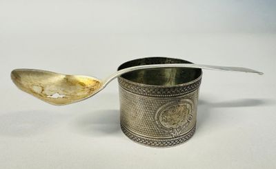 silver plated spoon with handle and handle on white surface