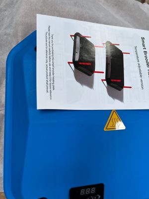 a blue plastic container with two electronic devices on top of it
