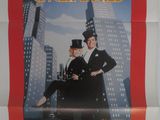 an old movie poster of a man and a woman in top hats