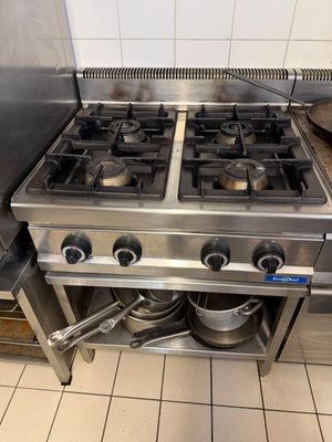 une cuisinière à deux feux sur laquelle est posée une casserole