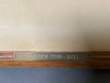 a close up of a wooden shelf with a sign on it
