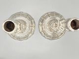 pair of silver plated candlesticks on a white background