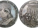 an image of a silver coin with a picture of a man on a horse