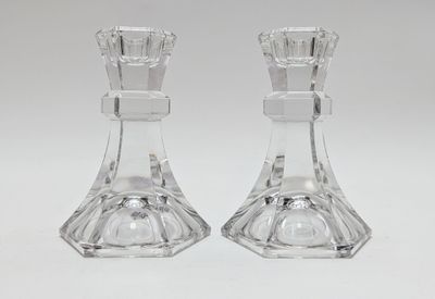 pair of clear glass candlestick holders on a white background