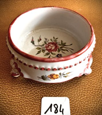 a small bowl with a flower design on it