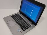 a laptop computer sitting on a table with a blue screen