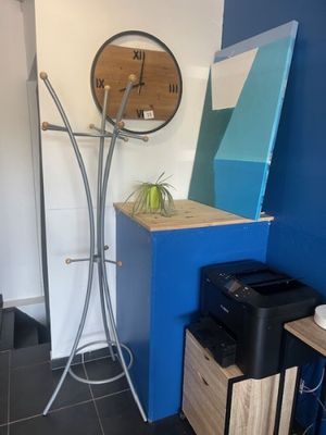 an image of a room with a blue wall and a clock on the wall