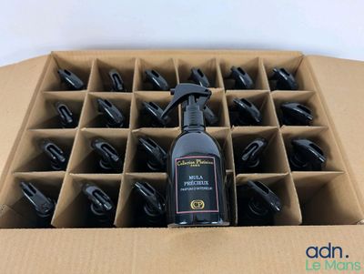 a bottle of cleaner sitting in a cardboard box