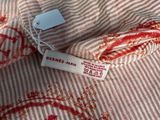 a close up of a red and white striped shirt with a tag on it