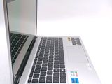 a silver laptop with a black keyboard on a white surface