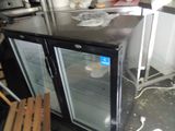an image of a refrigerator in a kitchen with a lot of clutter on the floor