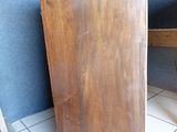 a wooden cabinet sitting on a tiled floor in a room