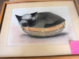 a picture of a cat that is sleeping in a basket