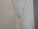 a wine glass sitting on top of a white table