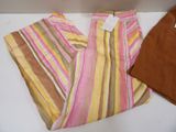 striped pants and a brown shirt are on a white table