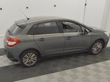 a picture of a grey car parked in a garage
