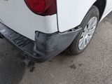 a picture of a white truck with a dent in it ' s rear end