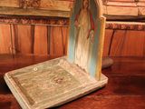 a small statue of jesus on a table in a room