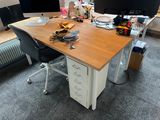 a desk with two monitors and a chair in front of it