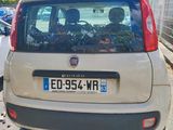 a small car that is parked on the side of the street