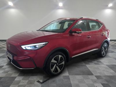 a red suv parked on a checkered floor in a showroom