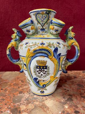 a vase that has a coat of arms on it