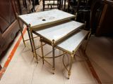 three tables that have marble tops on them in a room