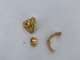 a pair of gold ear cuffs and a gold nose ring