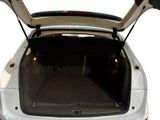 the trunk of a white car with its open doors open