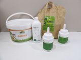 a bucket of liquid, two bottles of liquid, and a paper bag on a table