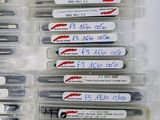 several pens are lined up in a row on top of each other