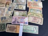 a lot of old and new canadian bank notes on the table