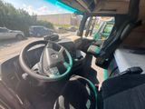 a view from inside of a vehicle of the driver ' s seat and steering wheel