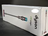 boxed box of a vacuum cleaner on a table with a black background